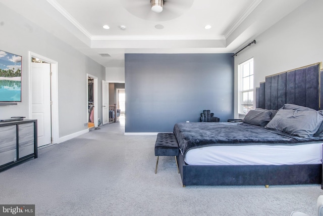 bedroom with ceiling fan and a raised ceiling