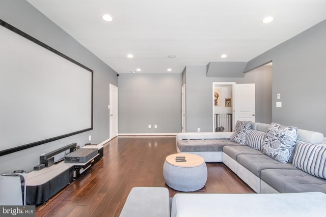 cinema room featuring dark wood-type flooring