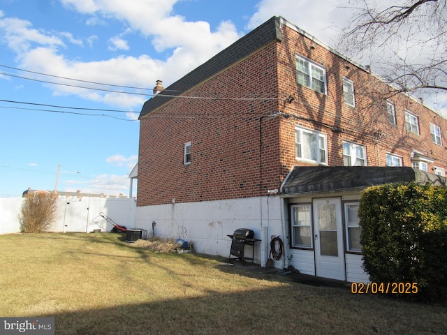 exterior space with a yard and central AC unit