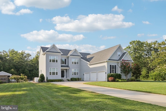 view of front of home with a front yard and a garage