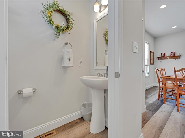 bathroom with sink and wood-type flooring