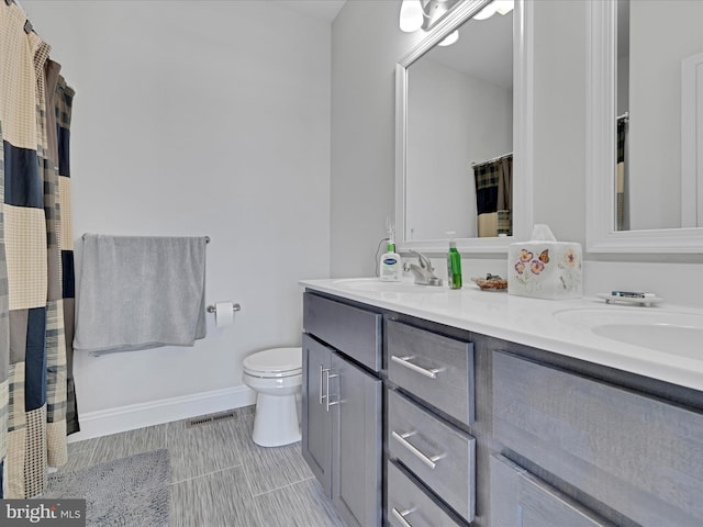 bathroom featuring toilet and vanity