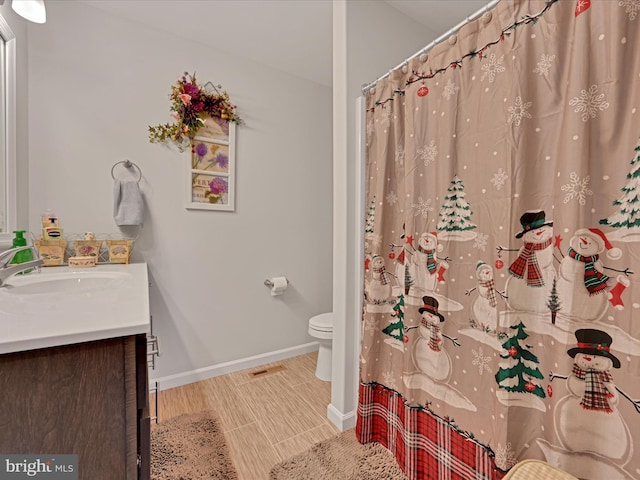 bathroom with toilet and vanity