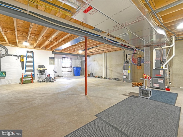 basement featuring heating unit and water heater