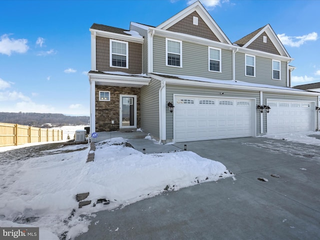 view of front of home with a garage and central AC unit