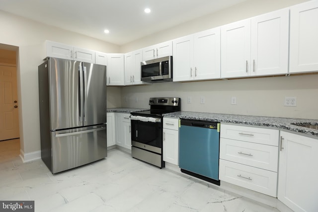 kitchen featuring light stone counters, white cabinetry, and appliances with stainless steel finishes