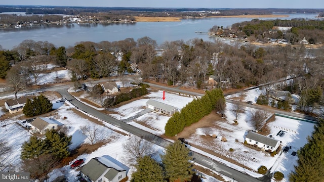 snowy aerial view with a water view