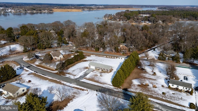 snowy aerial view with a water view