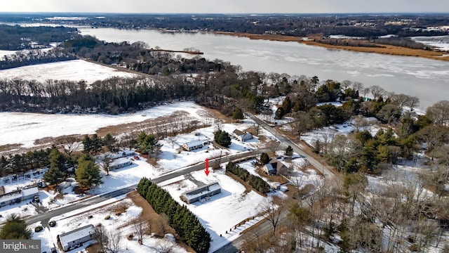 snowy aerial view featuring a water view