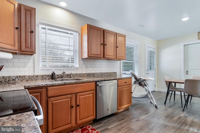 kitchen with stainless steel appliances, dark hardwood / wood-style flooring, sink, and decorative backsplash