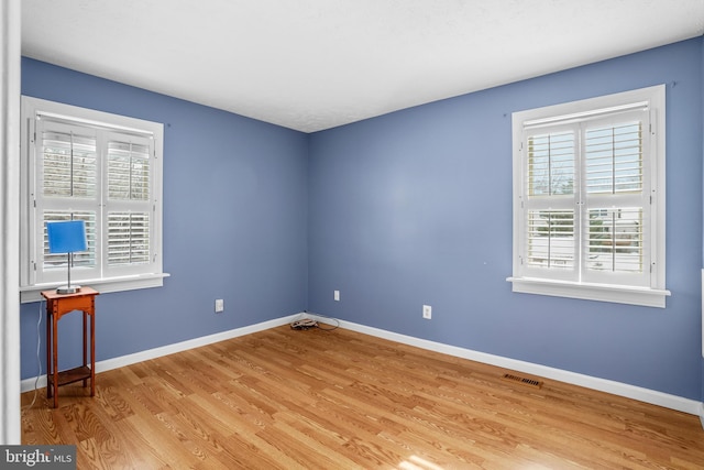 unfurnished room with light hardwood / wood-style floors