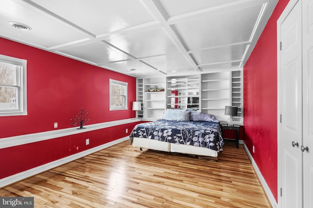 bedroom featuring hardwood / wood-style floors and coffered ceiling