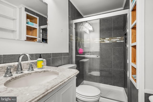 bathroom featuring tile walls, toilet, vanity, and walk in shower