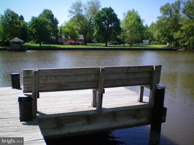 view of dock with a water view and a gazebo