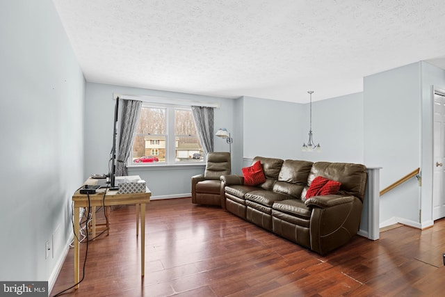 living room with a textured ceiling and dark hardwood / wood-style flooring