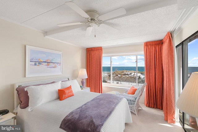 bedroom with crown molding, ceiling fan, a water view, carpet, and a textured ceiling