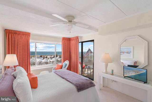 carpeted bedroom with multiple windows, a textured ceiling, and ceiling fan