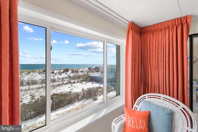 sunroom / solarium featuring a water view