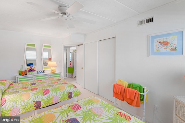 bedroom featuring ceiling fan, a closet, and ornamental molding