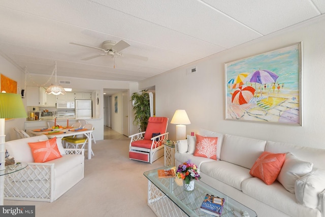 living room with light carpet and ceiling fan