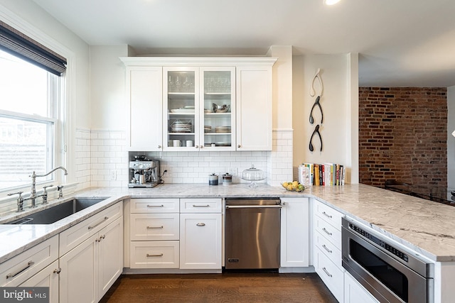 kitchen featuring white cabinetry, sink, and stainless steel microwave