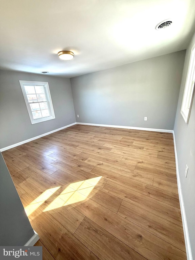 spare room with light hardwood / wood-style flooring