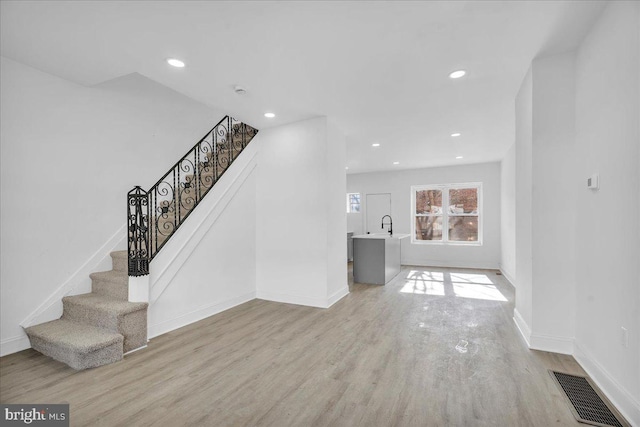 unfurnished living room with light hardwood / wood-style flooring