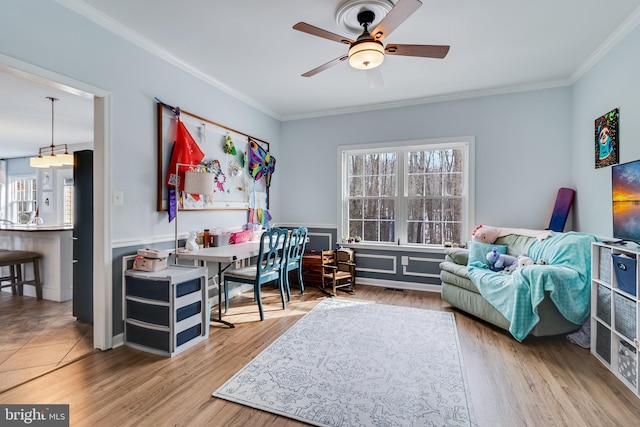 sitting room featuring hardwood / wood-style floors, ornamental molding, and ceiling fan