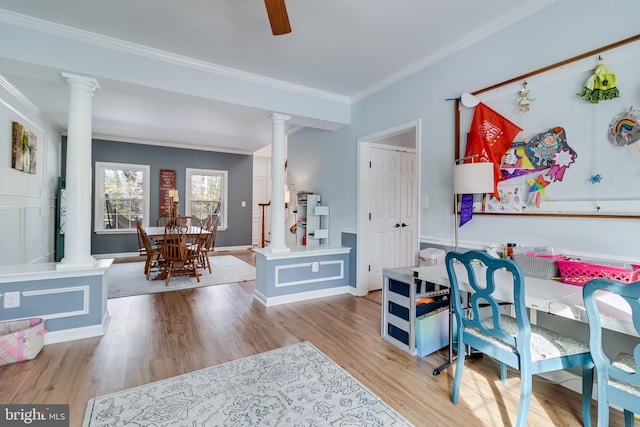 interior space with ornate columns, ornamental molding, and light hardwood / wood-style floors