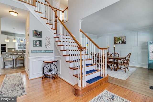 stairs featuring hardwood / wood-style floors