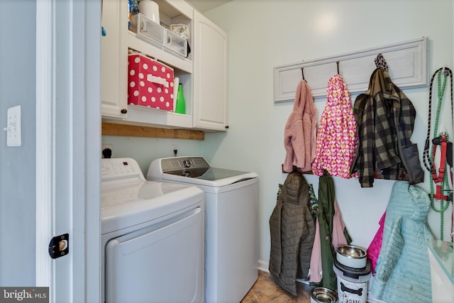 laundry room featuring cabinets and washer and dryer