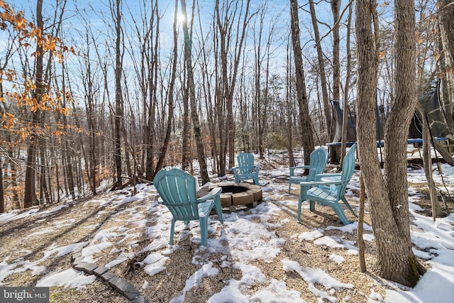 snowy yard with a fire pit