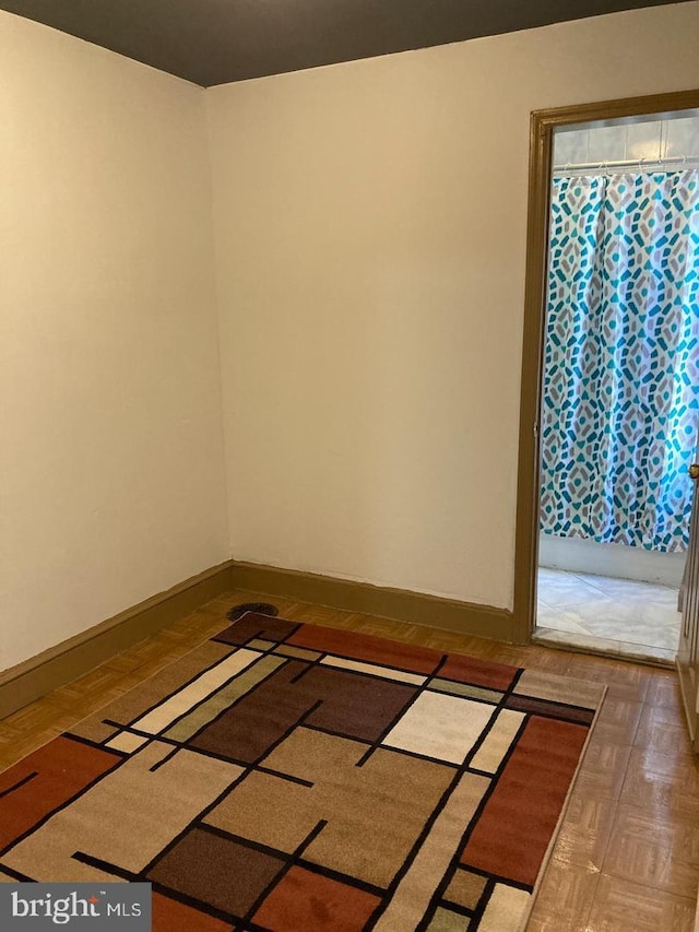 empty room featuring parquet flooring