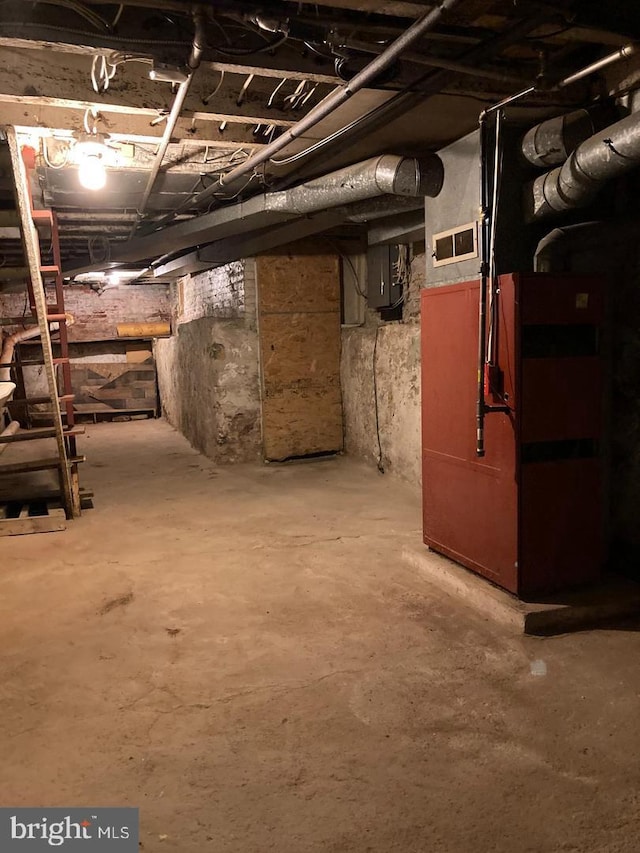 basement featuring heating unit and electric panel