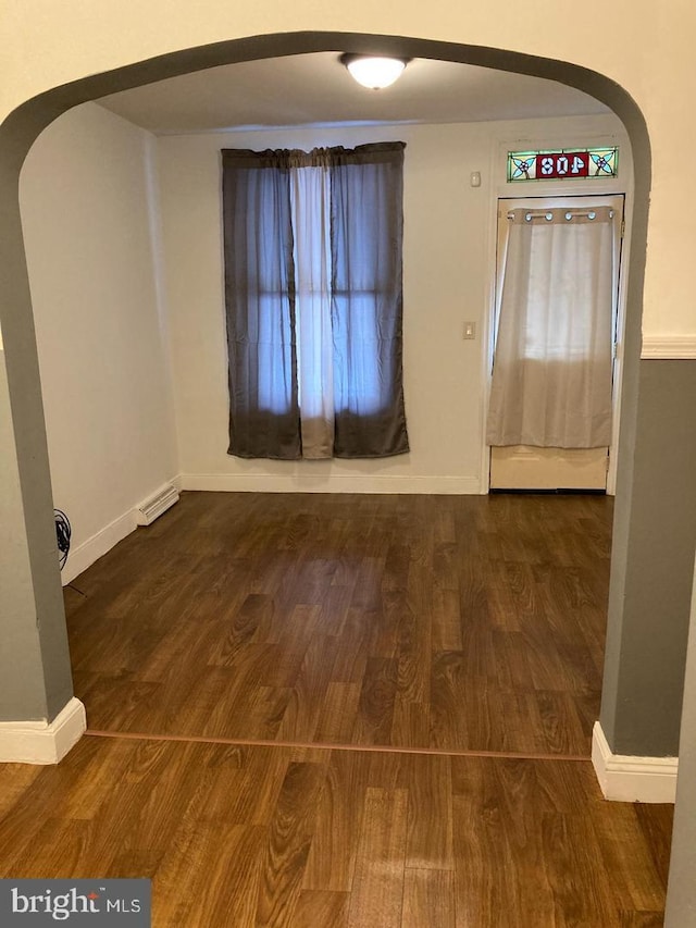 empty room with dark hardwood / wood-style flooring