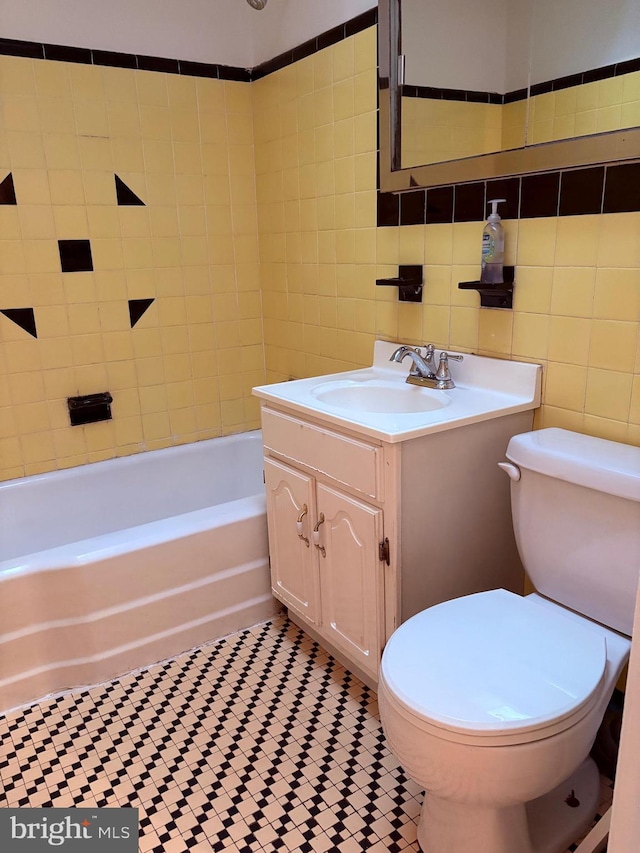 full bathroom featuring tile patterned floors, vanity, toilet, and  shower combination