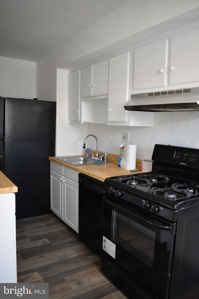 kitchen with sink, wooden counters, white cabinetry, black appliances, and dark hardwood / wood-style flooring