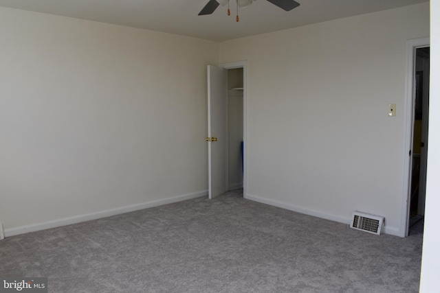 spare room featuring light colored carpet and ceiling fan