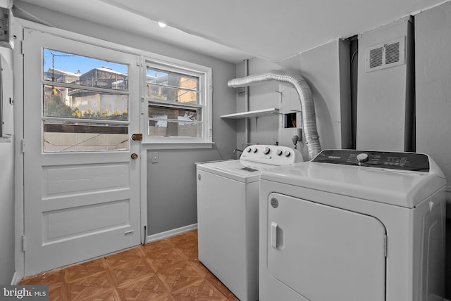 laundry area with separate washer and dryer and a healthy amount of sunlight