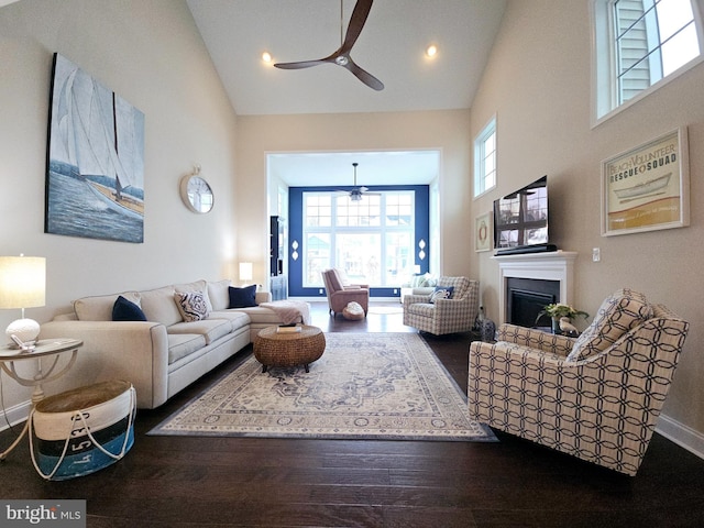 living room featuring ceiling fan, high vaulted ceiling, and wood-type flooring