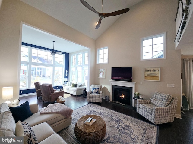 living room featuring ceiling fan, high vaulted ceiling, and dark hardwood / wood-style flooring