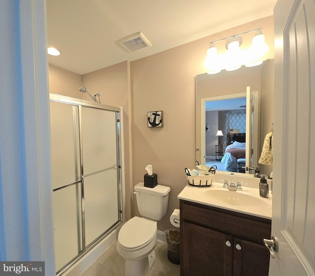 bathroom with toilet, a shower with shower door, tile patterned floors, and vanity