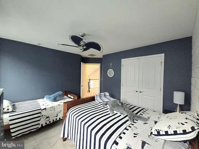 bedroom with ceiling fan, a closet, and carpet flooring