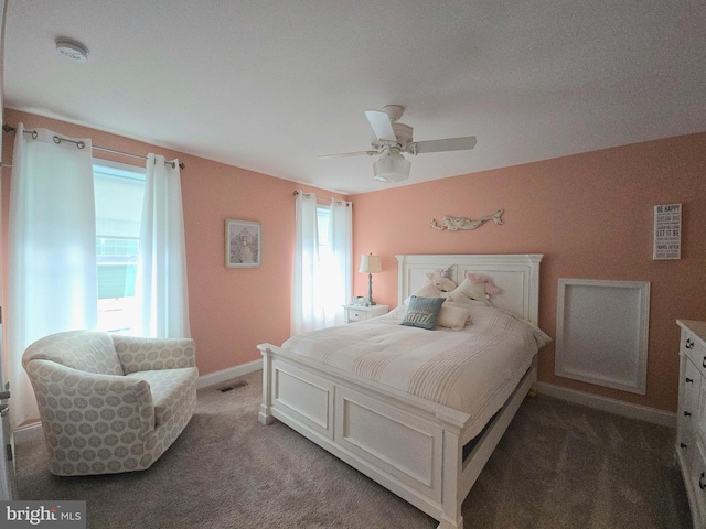 bedroom featuring dark carpet and ceiling fan