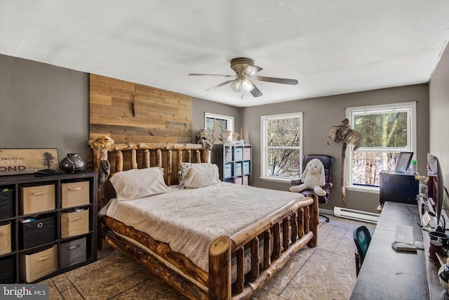 bedroom with baseboard heating, ceiling fan, and wooden walls