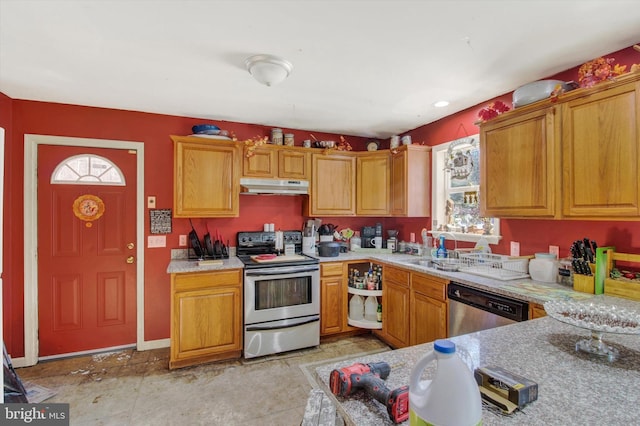 kitchen with stainless steel appliances, a wealth of natural light, and light stone counters