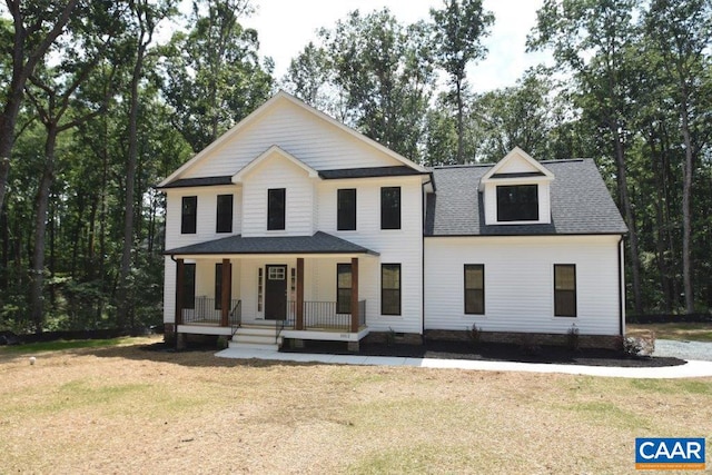 view of front of property with covered porch and a front lawn