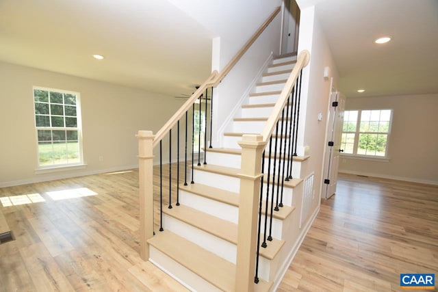 stairs featuring wood-type flooring