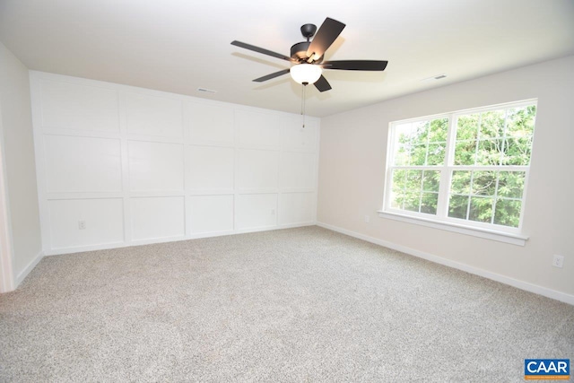 spare room featuring ceiling fan and carpet flooring