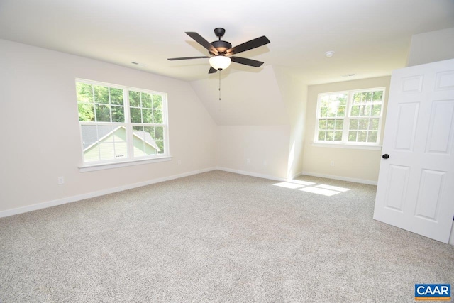 additional living space with ceiling fan, carpet, and lofted ceiling